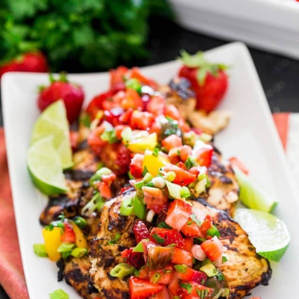 cilantro lime chicken topped with strawberry salsa on a plate