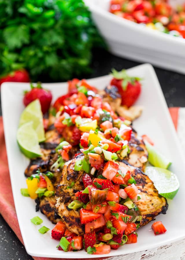 cilantro lime chicken topped with strawberry salsa on a plate