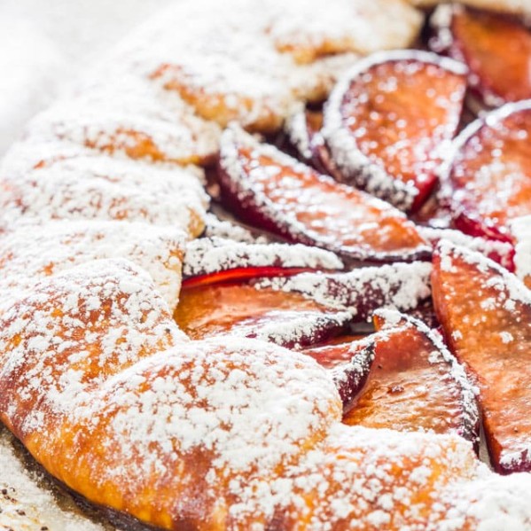 freshly baked plum galette dusted with powdered sugar