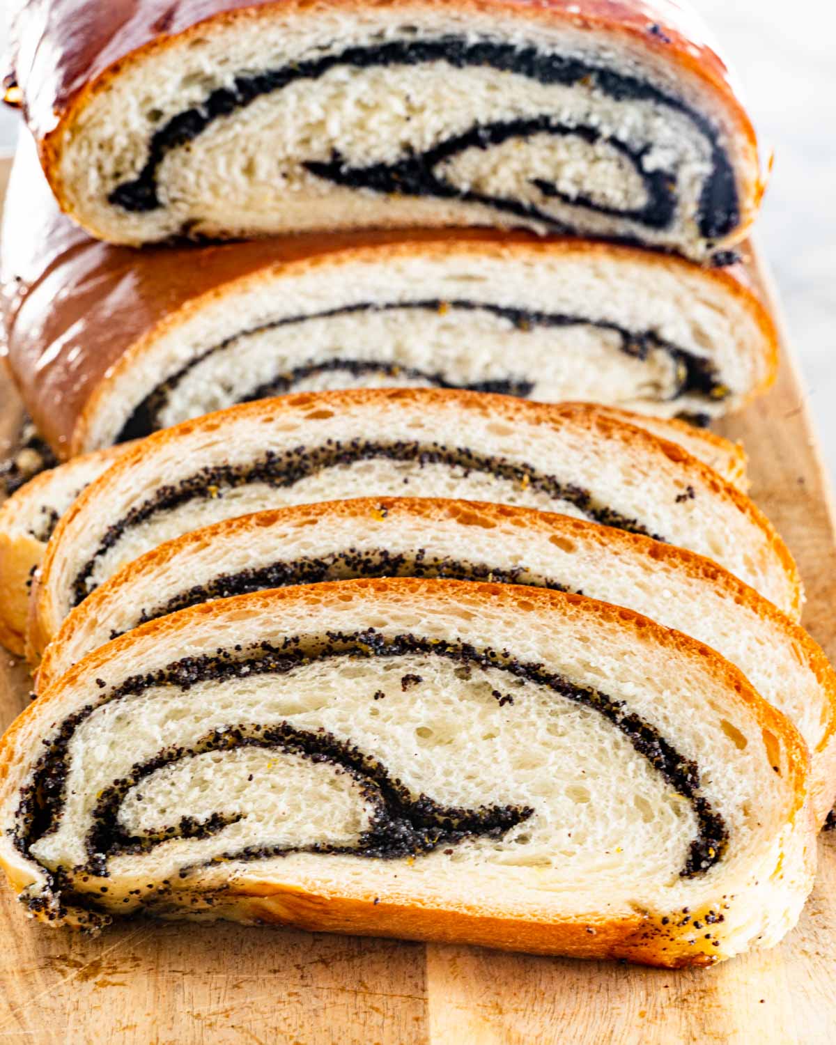 a sliced poppy seed roll on a cutting board