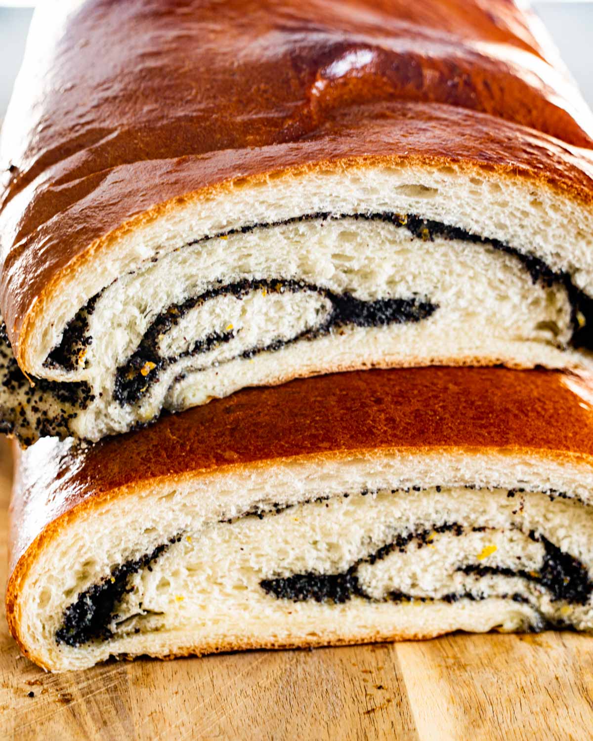 a poppy seed roll cut in half and stacked on a poppy seed roll