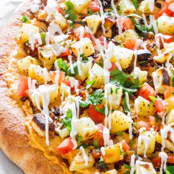 red lentil sweet potato pizza drizzled with crema