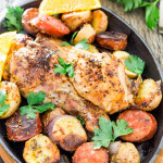 a skillet full of spanish chicken with chorizo and potatoes
