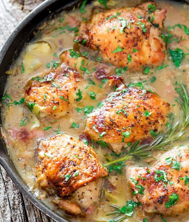 chicken with artichoke and pancetta pan sauce in a skillet