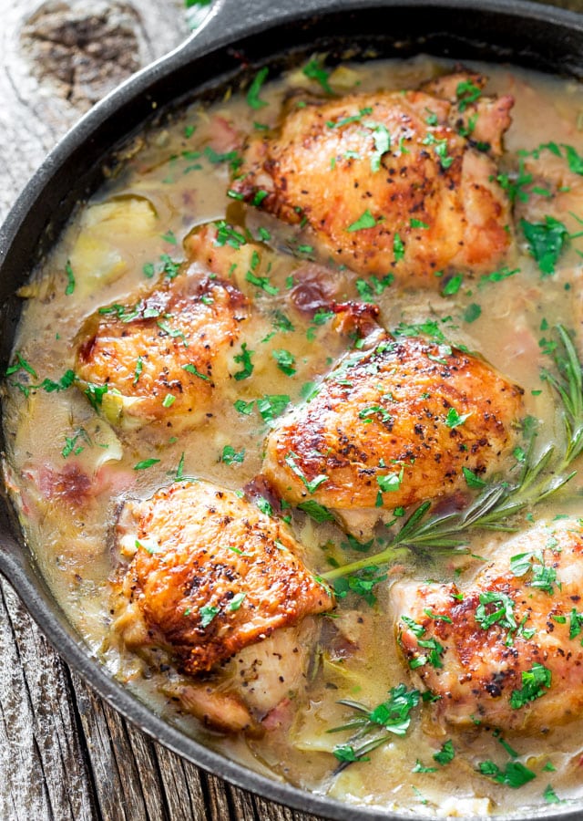 chicken with artichoke and pancetta pan sauce in a skillet