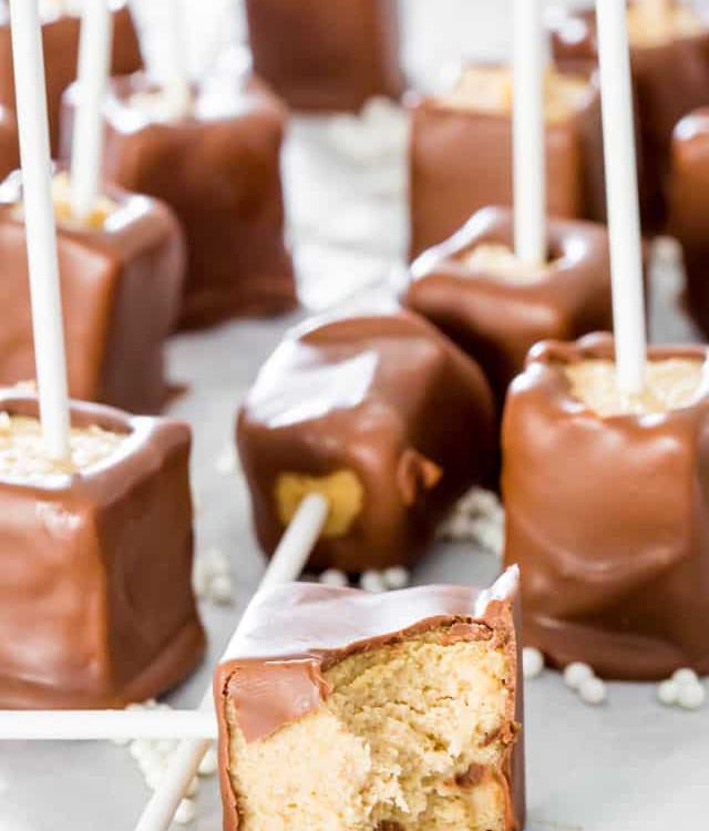 chocolate peanut butter cheesecake pops with a bite taken from one
