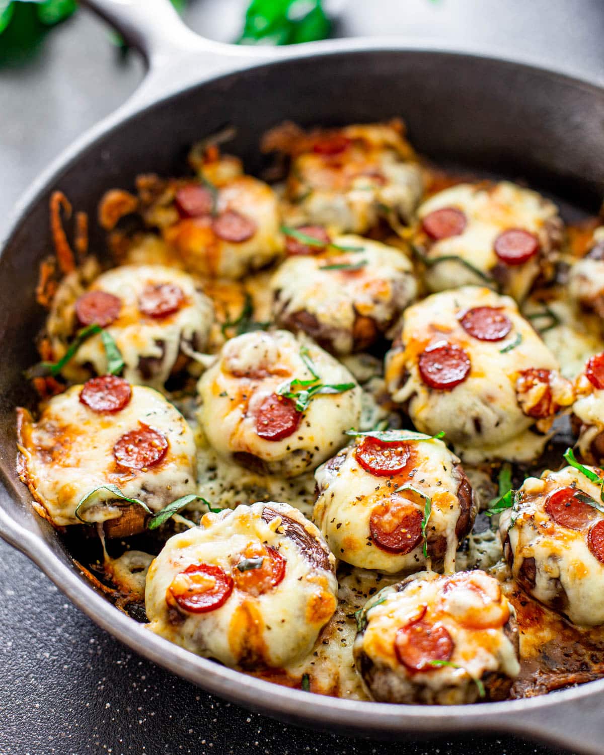 pizza stuffed mushrooms fresh out of the oven in a skillet