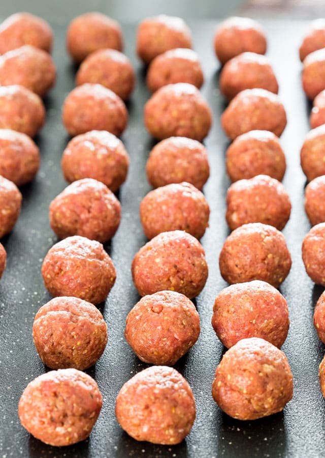 uncooked meatballs on a cutting board
