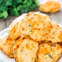 a pile of cheddar bay biscuits on a plate