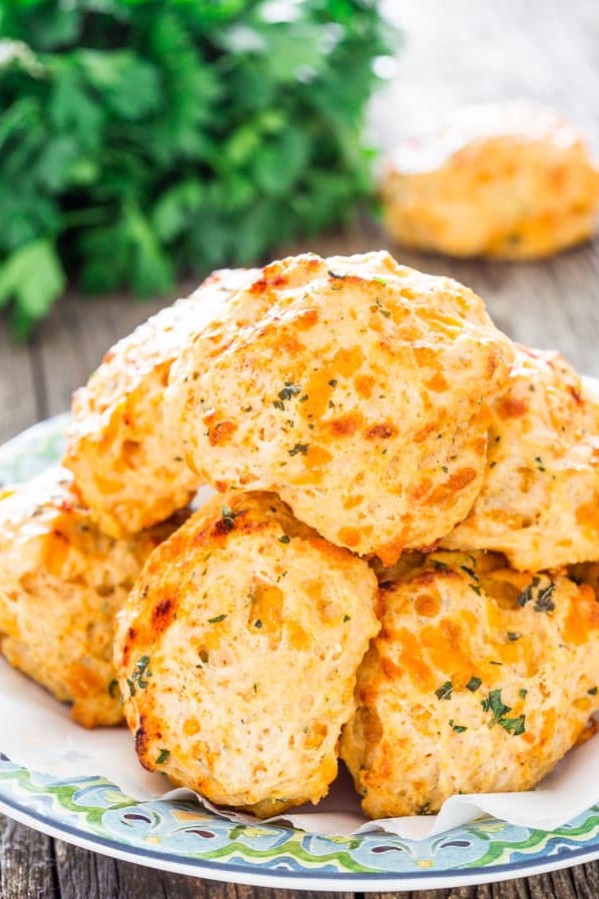 a pile of cheddar bay biscuits on a plate