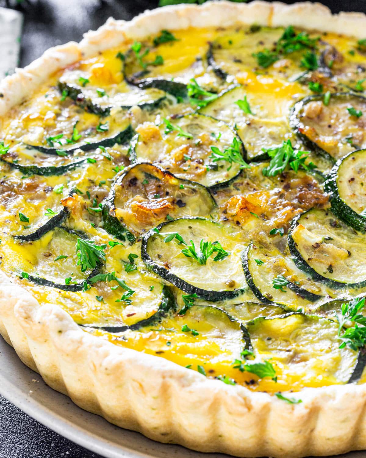 a zucchini quiche on a plate fresh out of the oven