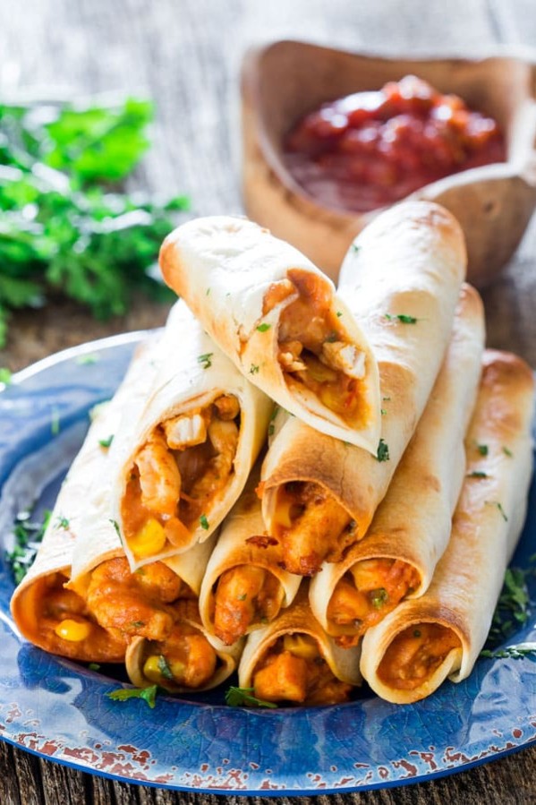 a stack of chicken taco taquitos on a plate