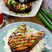 a plate of rice topped with a maple soy grilled salmon steak