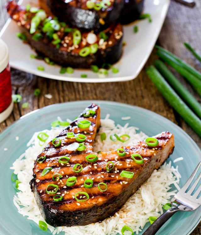a plate of rice topped with a maple soy grilled salmon steak