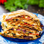 a stack of grilled vegetable quesadillas on a blue plate