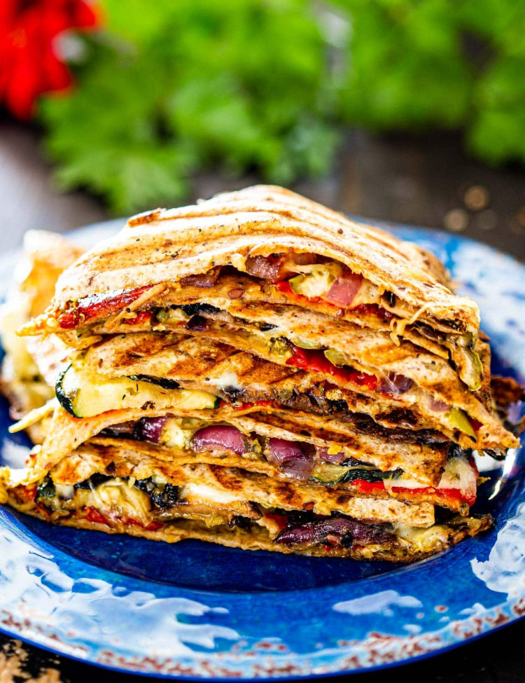 a stack of grilled vegetable quesadillas on a blue plate