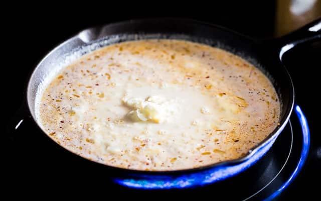 cooking a creamy sauce in a skillet