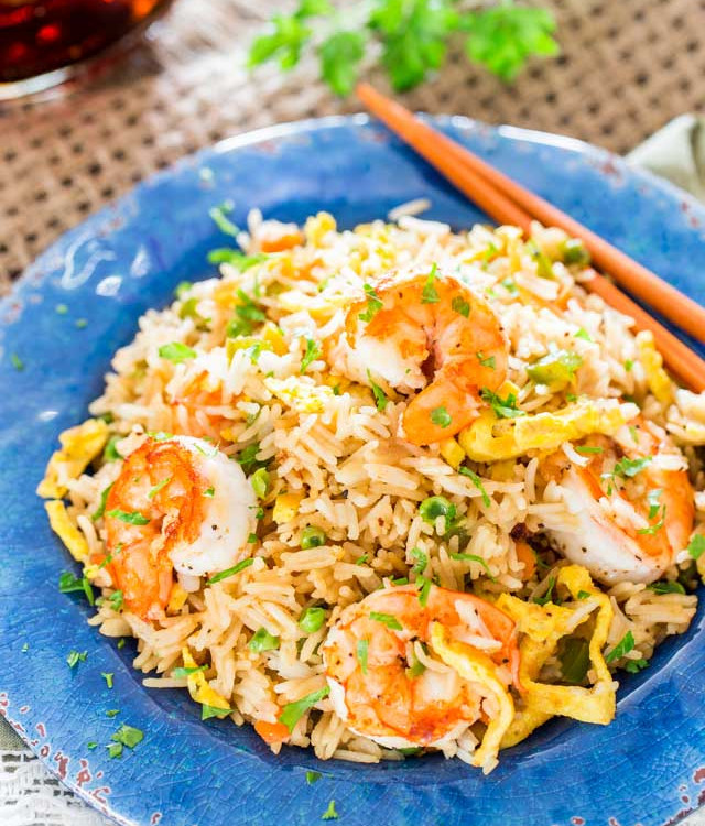 shrimp fried rice on a plate with chopsticks