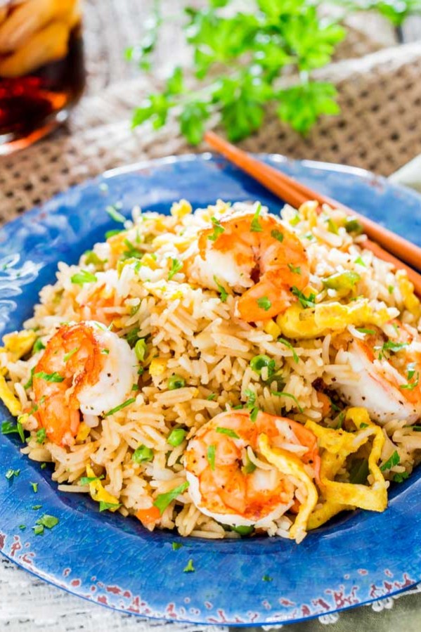 a plate full of shrimp fried rice