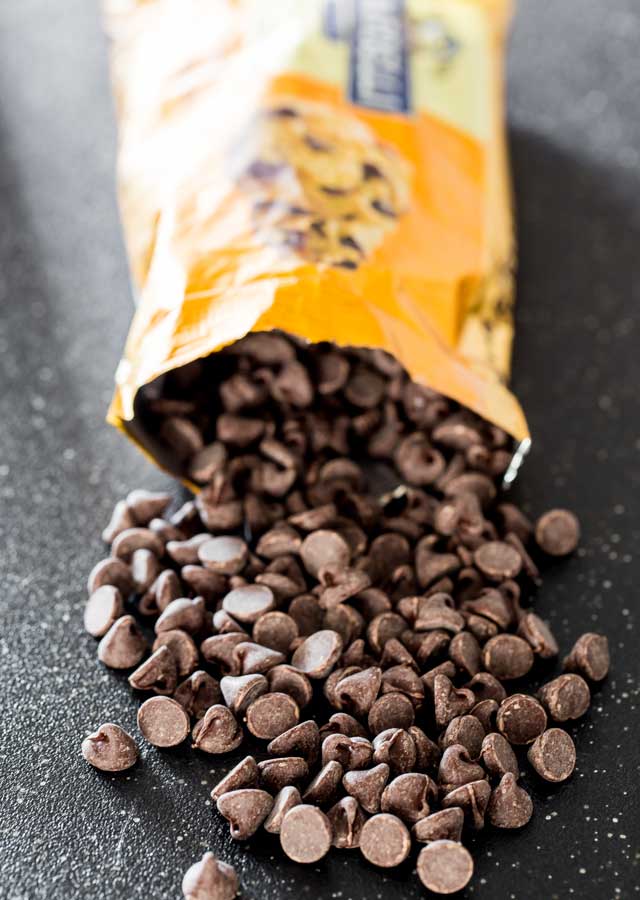 an open bag of Ghirardelli chocolate chips with a few chips fallen out