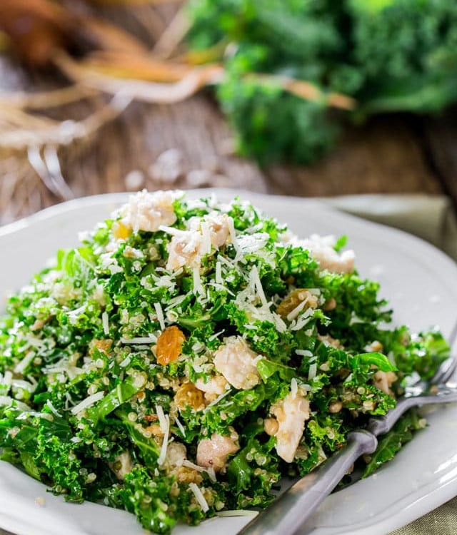 a plate of kale and quinoa salad with a fork resting on the plate