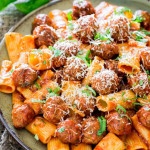 a plate of rigaton con polpette and arrabiata sauce