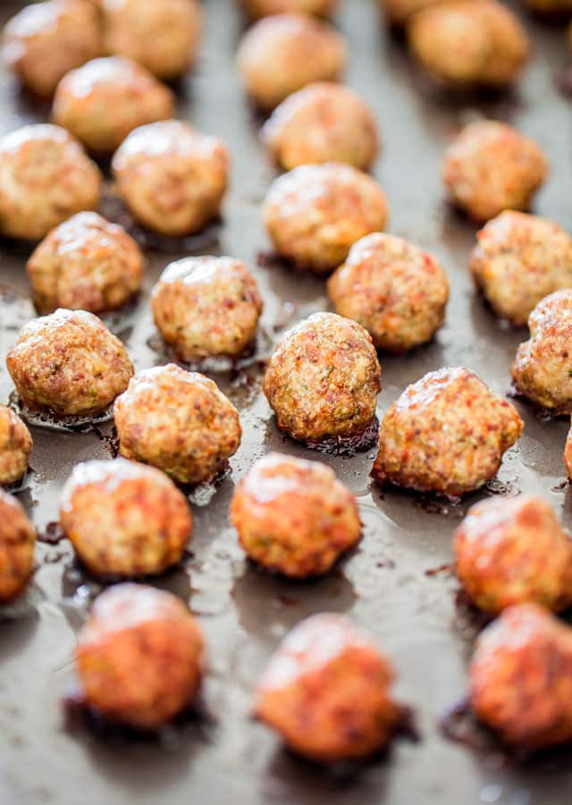 a sheet pan loaded with baked meatballs