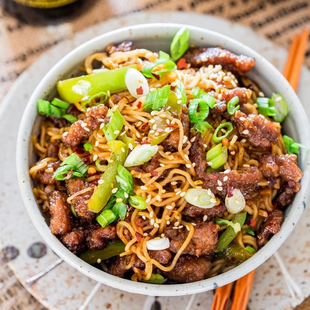 overhead shot of Mongolian Beef Ramen Noodles in a bowl garnished with green onions