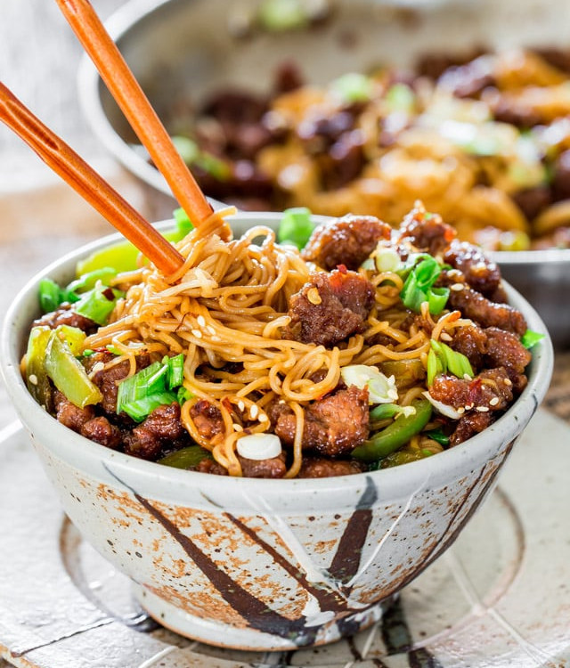 chopsticks stuck in a bowl full of mongolian beef ramen noodles