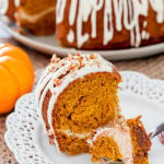 a fork taking a bite of pumpkin bundt cake with cream cheese filling