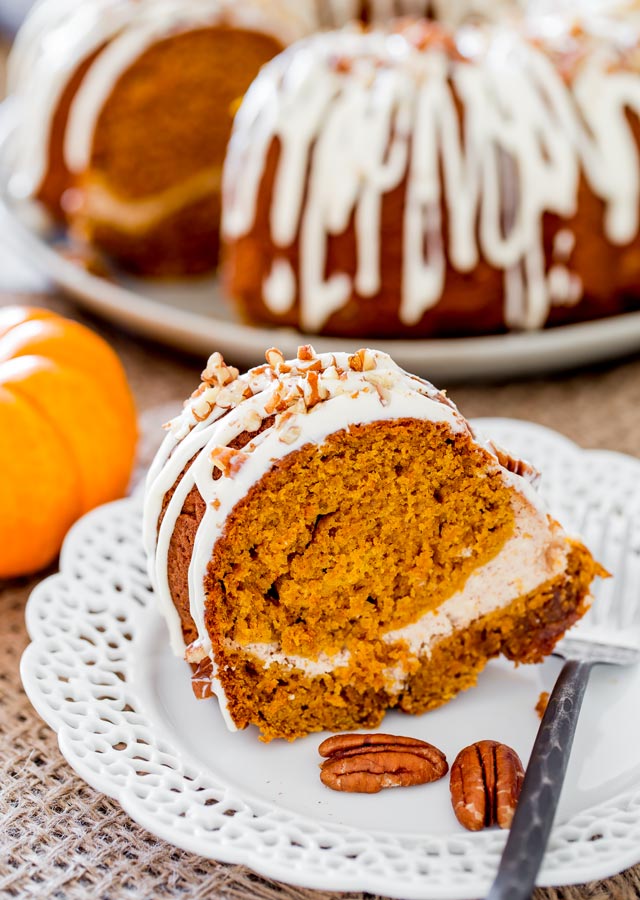 a piece of pumpkin bundt cake with cream cheese filling