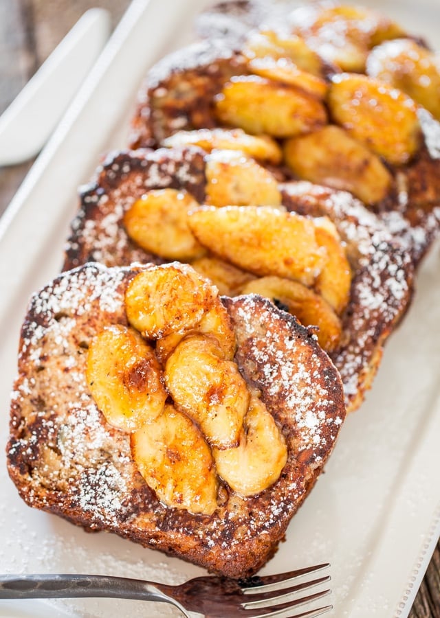 Banana Bread French Toast with Caramelized Bananas and dusted with powdered sugar