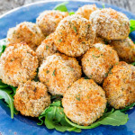 a plate full of crispy baked parmesan garlic breaded mushrooms