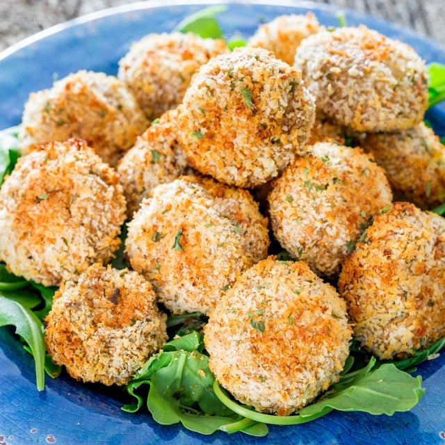 Parmesan Garlic Breaded Mushrooms piled up on a plate