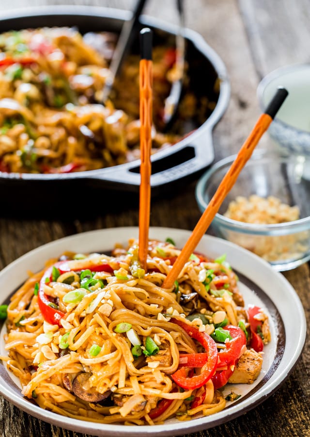 a plate of Spicy Thai Chicken and Veggie Noodles with a set of chopsticks