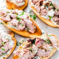 blue cheese and steak crostinis garnished with parsley