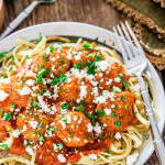 a plate full of cajun meatballs in fire roasted tomato sauce
