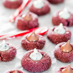 red velvet kiss cookies spread out on parchment paper
