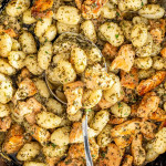 garlic butter chicken gnocchi in a black cast iron skillet.