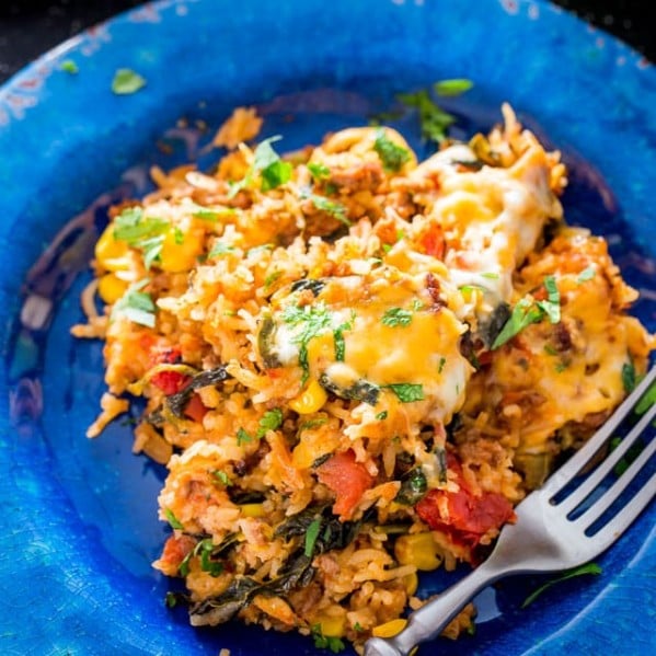 mexican beef and rice casserole on a plate with a fork