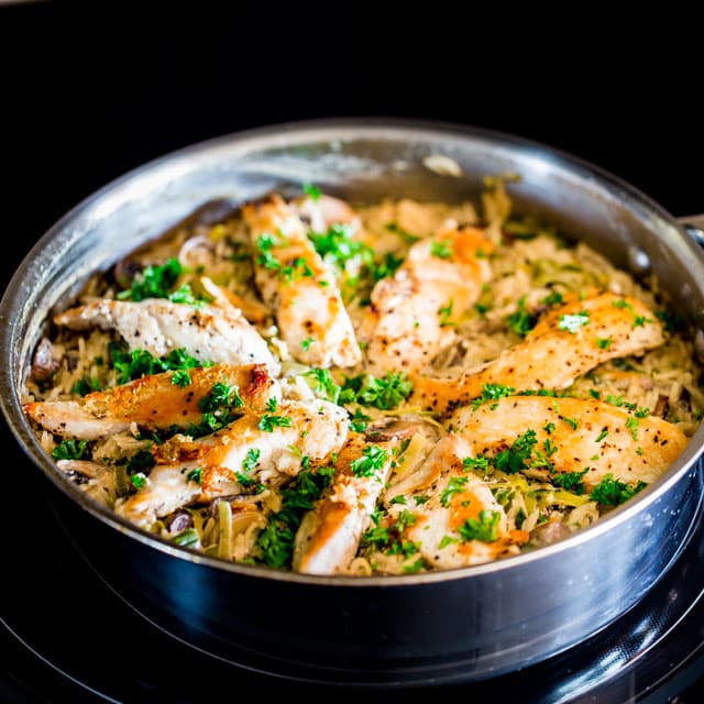 Creamy Chicken with Mushroom and Leek Rice cooking in a pan