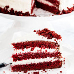 side view shot of a piece of red velvet cake on a plate