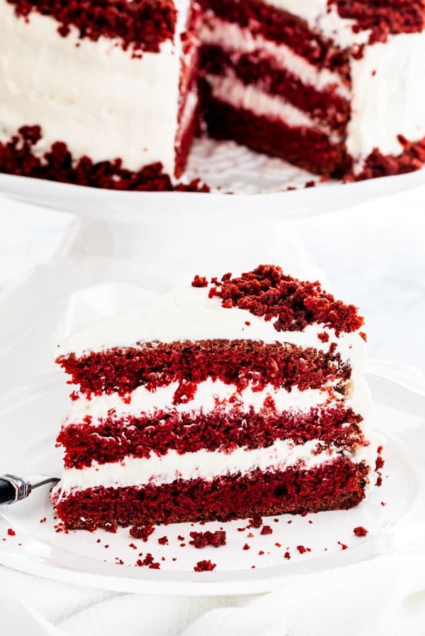 side view shot of a piece of red velvet cake on a plate