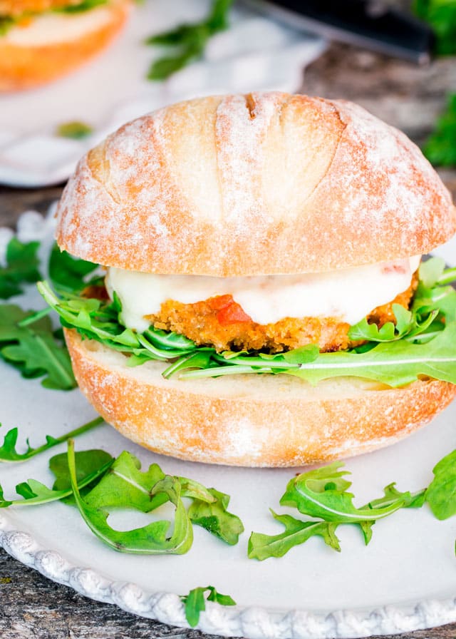 a Chicken Parmwich on a plate with arugula