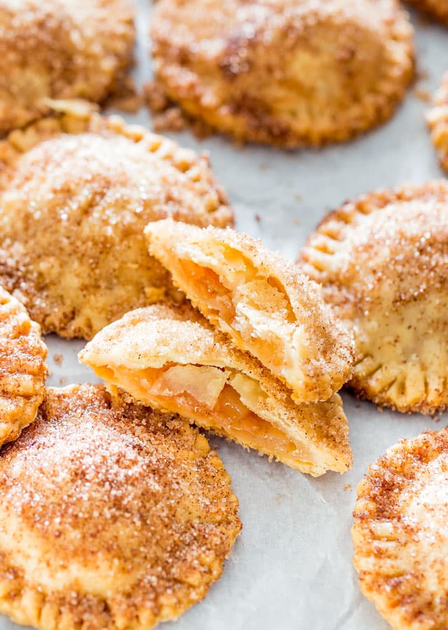 Churro Apple Pie Cookies on parchment paper with one split in half