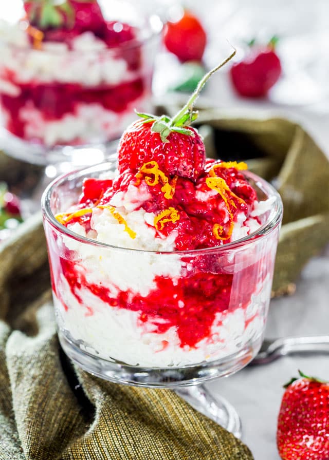 Coconut Rice Pudding topped with a strawberry and sauce 