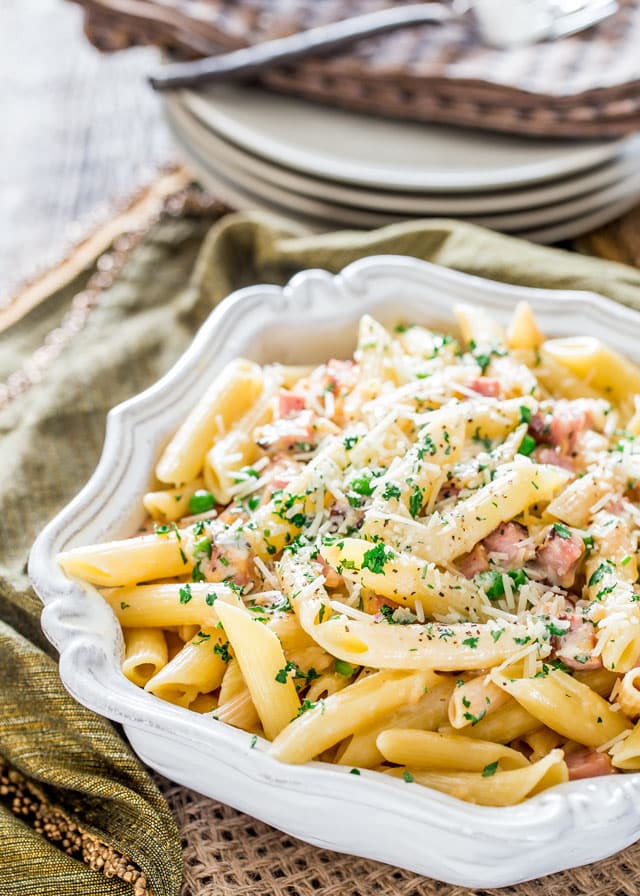 a serving bowl of Ham and Cheese Penne topped with parsley