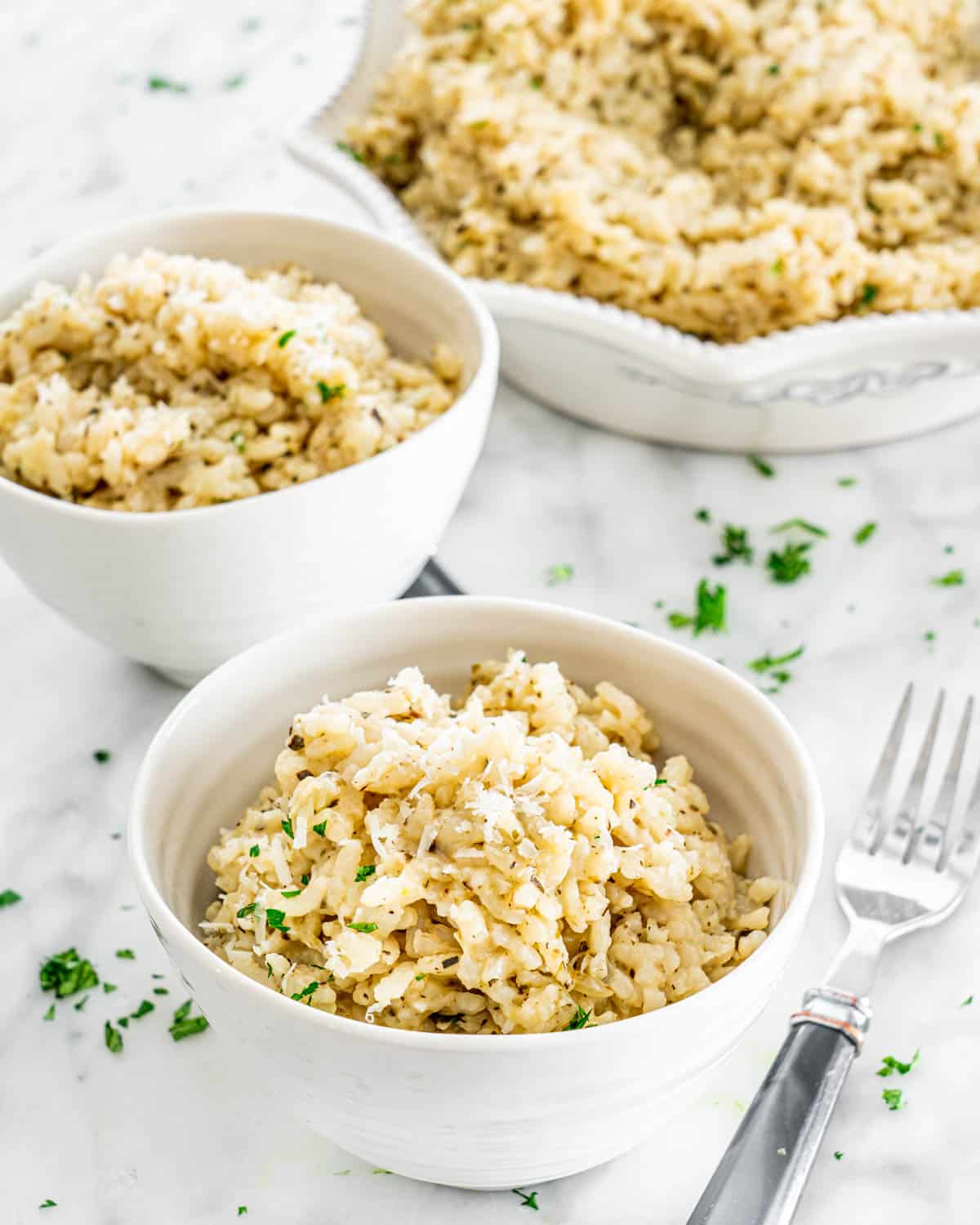 a couple small white bowls filled with risotto