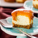 side view close up shot of a mini salted caramel cheesecake with a bite taken from it