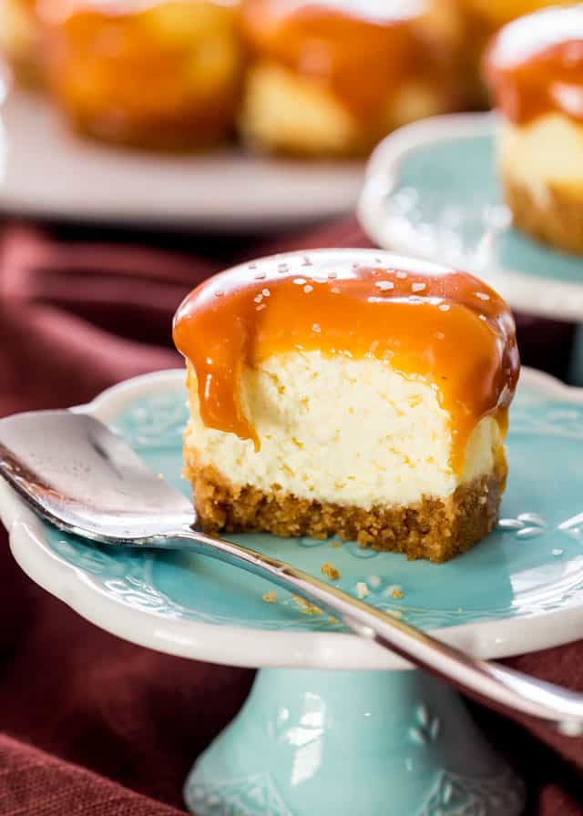 a Mini Salted Caramel Cheesecake on a blue dish with a bite taken from it